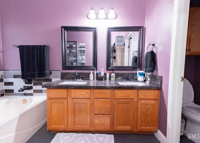 bathroom with toilet, vanity, tile patterned floors, and a tub to relax in