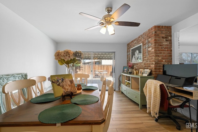 dining area featuring light wood finished floors and a ceiling fan