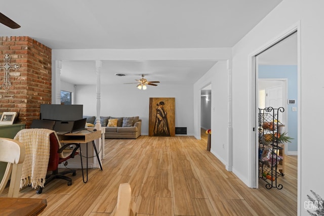 living area featuring ceiling fan, baseboards, visible vents, and light wood-style floors