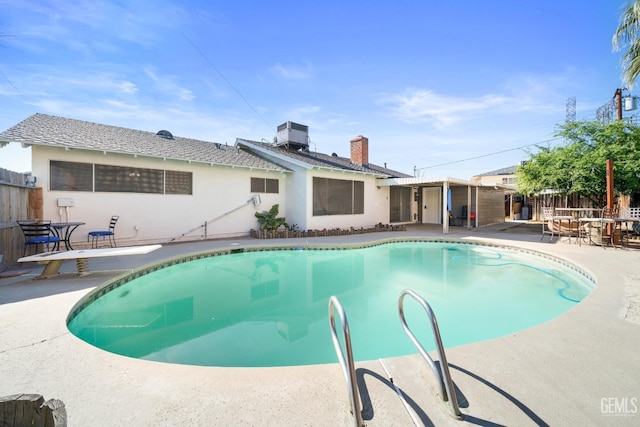 view of pool featuring a patio area, fence, a fenced in pool, and central air condition unit