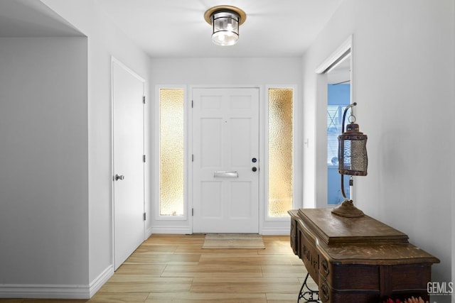 entryway with plenty of natural light and light wood-style flooring