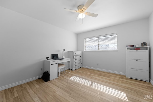 office featuring light wood-style flooring, baseboards, and a ceiling fan