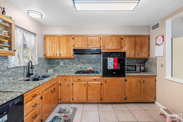 kitchen featuring sink, light stone counters, ventilation hood, light tile patterned floors, and black appliances