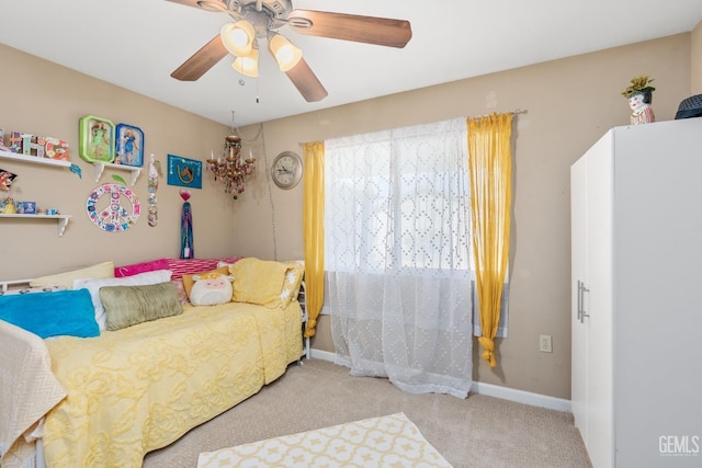 bedroom with light carpet and ceiling fan