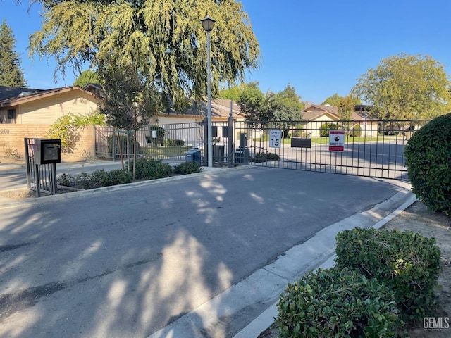 view of gate with fence and a residential view