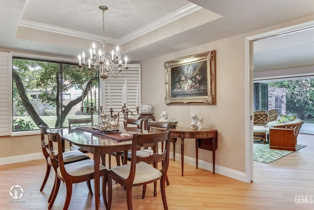 dining area featuring baseboards, a healthy amount of sunlight, and light wood-style floors