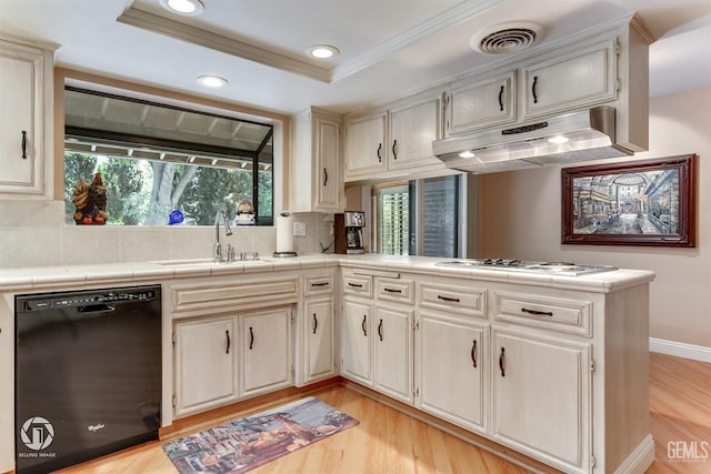 kitchen with visible vents, dishwasher, under cabinet range hood, a sink, and backsplash