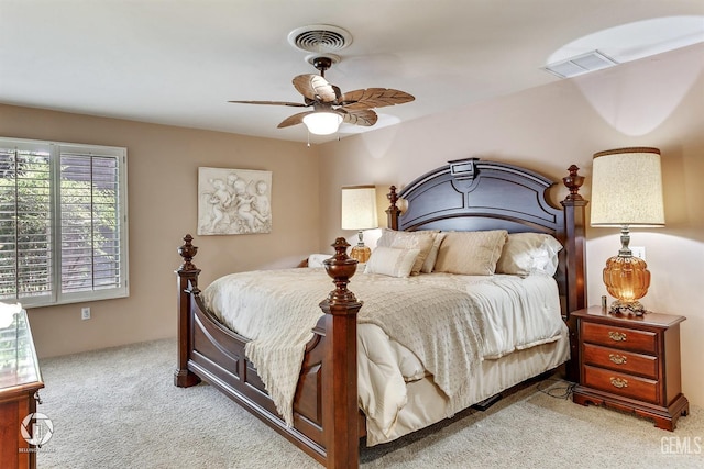 bedroom with visible vents, a ceiling fan, and light carpet