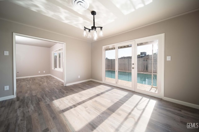 631 Union St, Delano, CA 93215 - unfurnished dining area with a chandelier, wood finished floors, french doors, baseboards, and ornamental molding