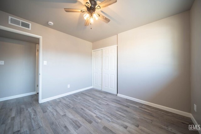 631 Union St, Delano, CA 93215 - unfurnished bedroom featuring wood finished floors, baseboards, a closet, and a ceiling fan