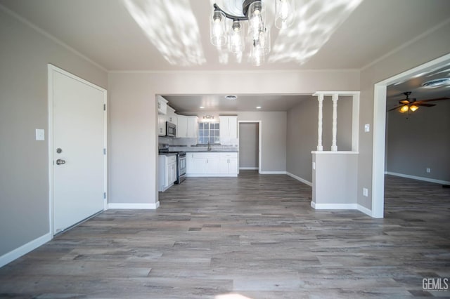631 Union St, Delano, CA 93215 - unfurnished living room with a ceiling fan, a chandelier, wood finished floors, baseboards, and ornamental molding