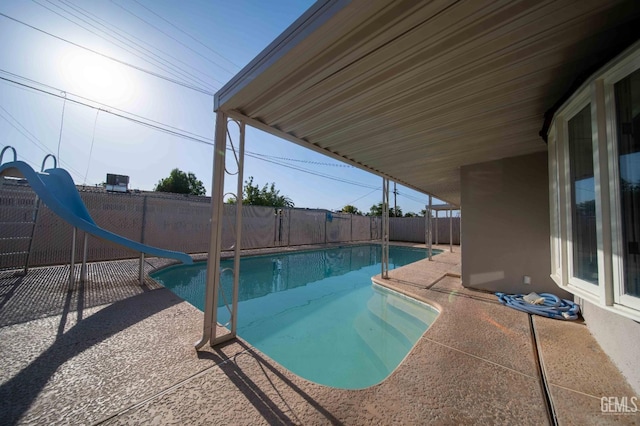 631 Union St, Delano, CA 93215 - view of swimming pool featuring a water slide, a fenced backyard, and a patio area