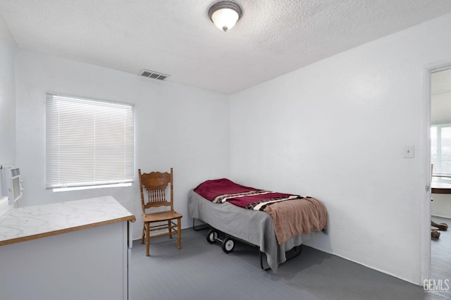 bedroom featuring visible vents and a textured ceiling