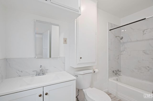 full bathroom featuring shower / washtub combination, decorative backsplash, vanity, and toilet