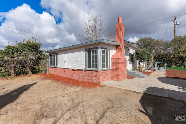 view of home's exterior with a chimney