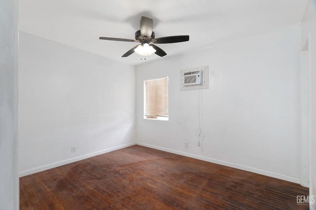 spare room featuring a ceiling fan, a wall mounted air conditioner, baseboards, and wood finished floors