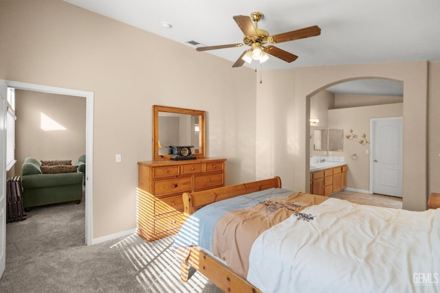 10116 Bay Colony Dr, Bakersfield, CA 93312 - bedroom featuring arched walkways, light carpet, baseboards, and ensuite bath