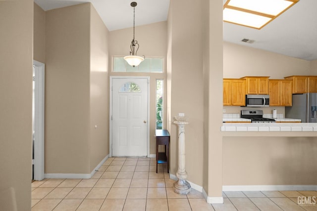 10116 Bay Colony Dr, Bakersfield, CA 93312 - entryway with high vaulted ceiling, baseboards, and light tile patterned floors