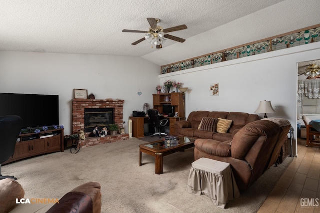 living room with a brick fireplace, a textured ceiling, vaulted ceiling, and a ceiling fan