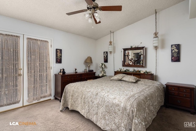 carpeted bedroom featuring ceiling fan, vaulted ceiling, and a textured ceiling