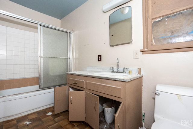 full bath featuring shower / bath combination with glass door, toilet, and vanity