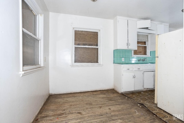 kitchen with white cabinets, backsplash, and dark wood finished floors