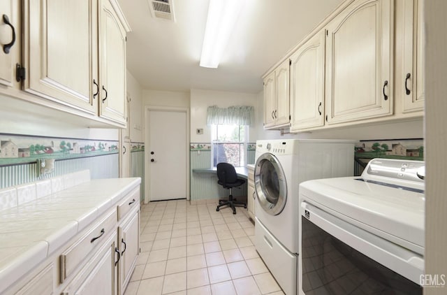 7001 Eloy Ave, Bakersfield, CA 93308 - clothes washing area with light tile patterned flooring, visible vents, washer and dryer, cabinet space, and wainscoting