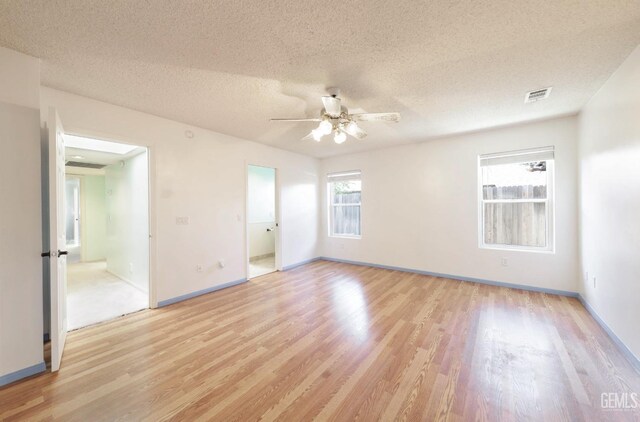 7001 Eloy Ave, Bakersfield, CA 93308 - unfurnished room with a ceiling fan, a textured ceiling, light wood-style flooring, baseboards, and visible vents