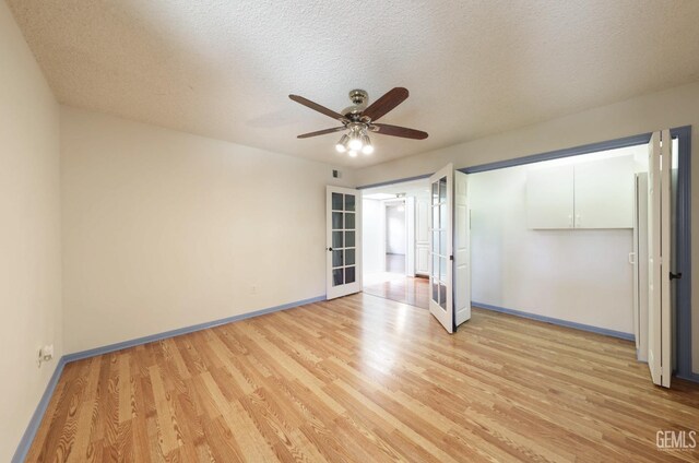7001 Eloy Ave, Bakersfield, CA 93308 - unfurnished bedroom with a ceiling fan, french doors, baseboards, a textured ceiling, and light wood-style flooring
