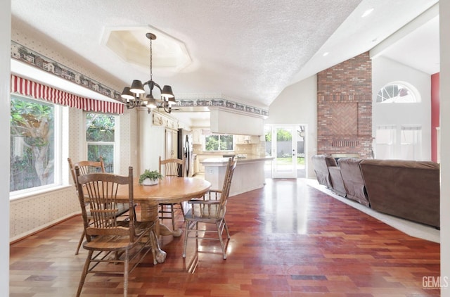 7001 Eloy Ave, Bakersfield, CA 93308 - dining space with a chandelier, wood finished floors, a textured ceiling, lofted ceiling, and wallpapered walls