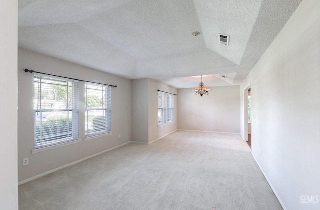 7001 Eloy Ave, Bakersfield, CA 93308 - unfurnished room with light carpet, a textured ceiling, baseboards, visible vents, and an inviting chandelier