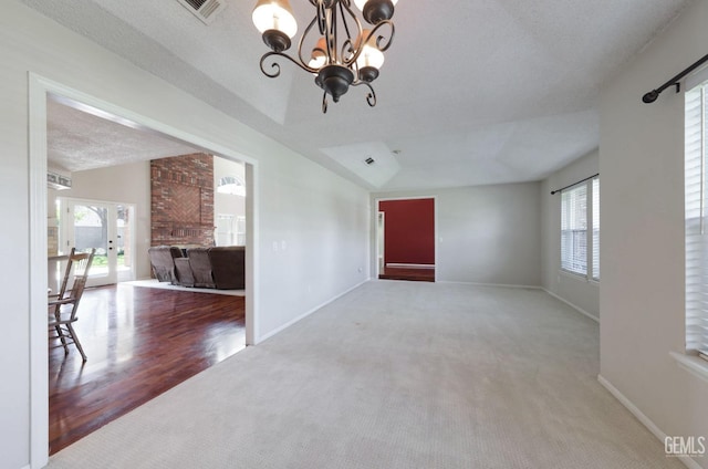 7001 Eloy Ave, Bakersfield, CA 93308 - interior space featuring a wealth of natural light, lofted ceiling, visible vents, and a textured ceiling