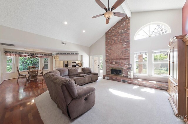 7001 Eloy Ave, Bakersfield, CA 93308 - living area with a fireplace, high vaulted ceiling, ceiling fan, and visible vents