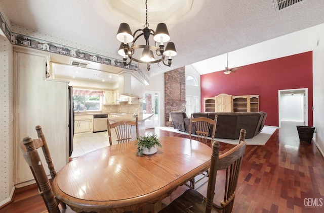 7001 Eloy Ave, Bakersfield, CA 93308 - dining area featuring ceiling fan with notable chandelier, visible vents, lofted ceiling, and light wood-type flooring