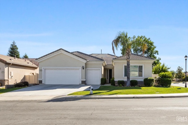 ranch-style house featuring driveway, a tile roof, an attached garage, a front lawn, and stucco siding