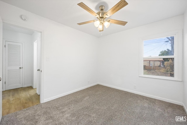 unfurnished room with ceiling fan and carpet floors