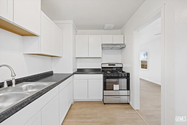 kitchen featuring light wood-type flooring, white cabinets, sink, and stainless steel gas stove