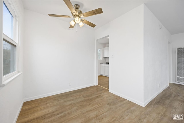 unfurnished room with ceiling fan and light hardwood / wood-style flooring