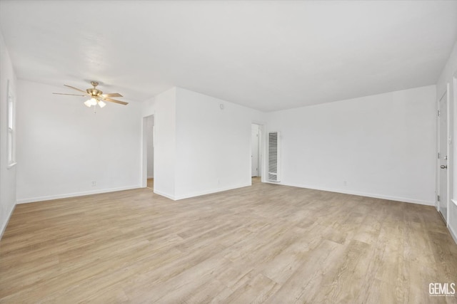 empty room with ceiling fan and light wood-type flooring