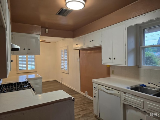 kitchen with white cabinetry, dark hardwood / wood-style floors, white dishwasher, stove, and exhaust hood