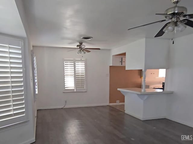 interior space featuring dark wood-type flooring and ceiling fan