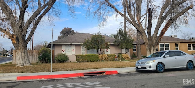 ranch-style home with a front lawn