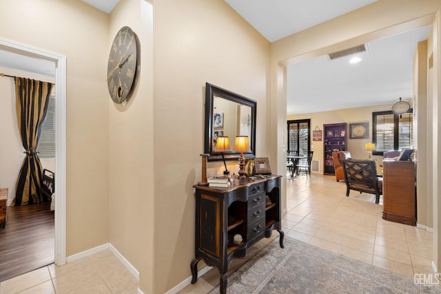 hall featuring light tile patterned floors