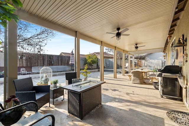 view of patio featuring a fire pit, grilling area, and ceiling fan