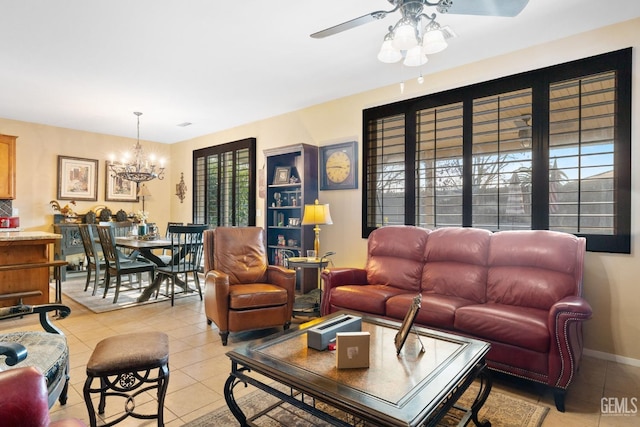 tiled living room featuring ceiling fan with notable chandelier