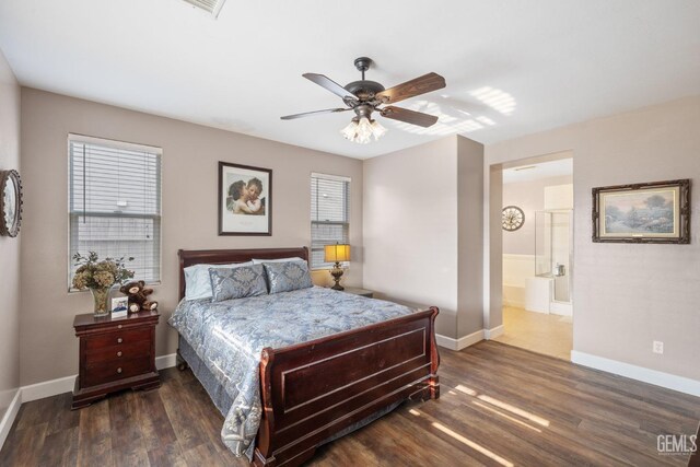 bedroom with ceiling fan, ensuite bathroom, and dark hardwood / wood-style floors