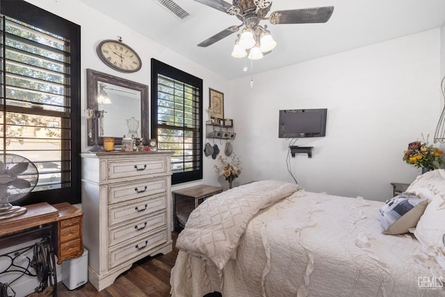 bedroom featuring ceiling fan and dark hardwood / wood-style flooring