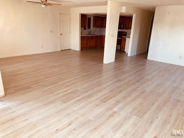 713 18th Pl, Delano, CA 93215 - unfurnished living room with a ceiling fan and light wood-style floors