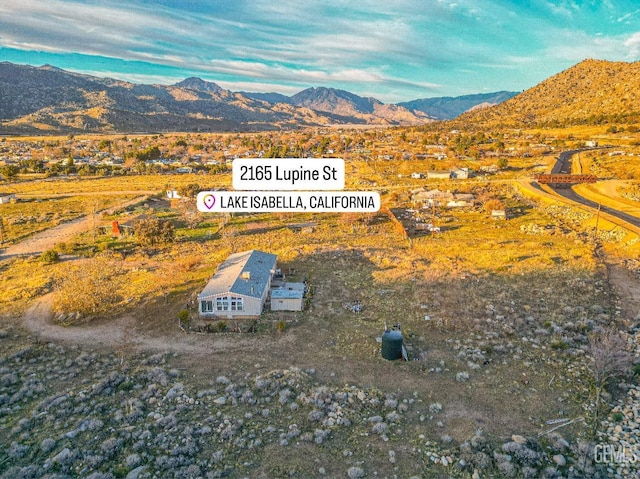 birds eye view of property with a mountain view