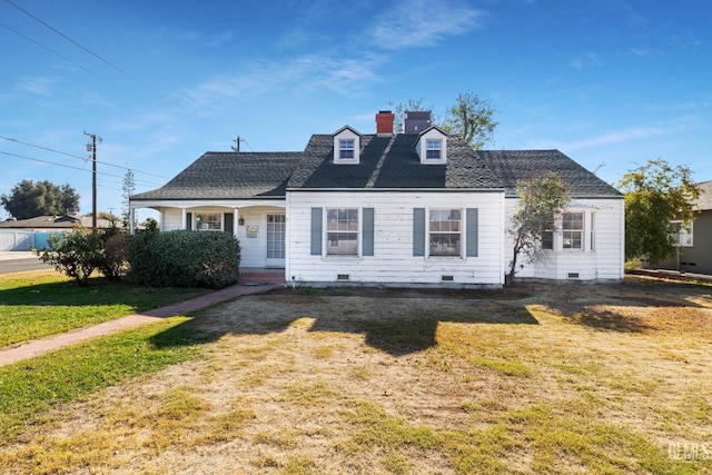 cape cod home with covered porch and a front lawn